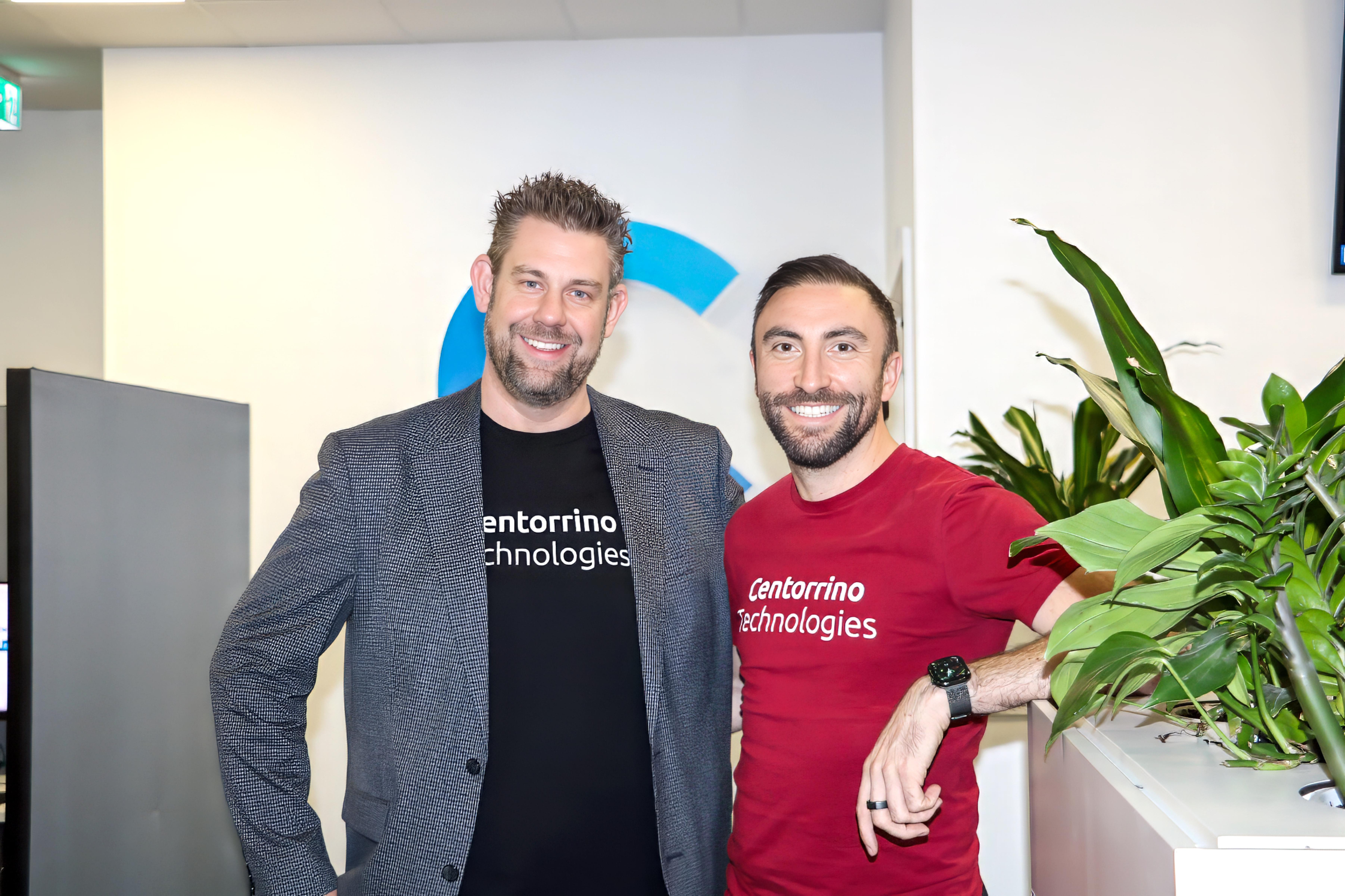 George Darwent and Adam Centorrino smiling at CT HQ, wearing Centorrino Technologies T Shirts.